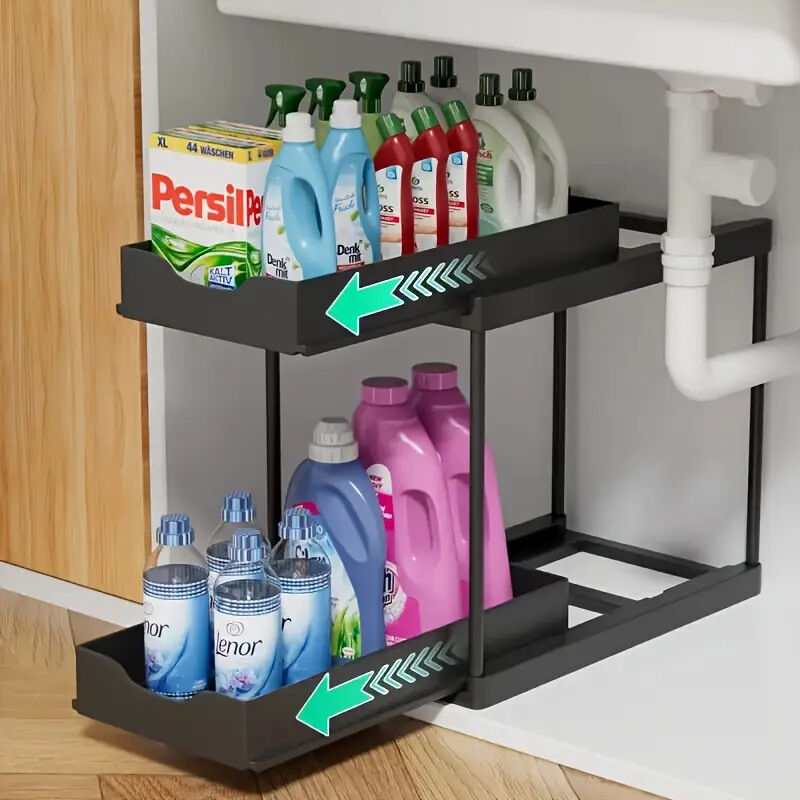 Two-tier pull-out storage rack. An organizational lifesaver for under the kitchen sink. Features adjustable shelves for easy storage of bottles and jars. In a sleek, modern design. Perfect as a kitchen shelf, bathroom organizer, or household storage solut