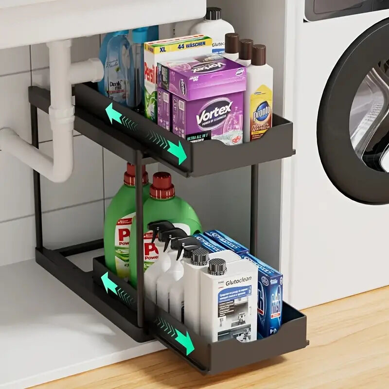 Two-tier pull-out storage rack. An organizational lifesaver for under the kitchen sink. Features adjustable shelves for easy storage of bottles and jars. In a sleek, modern design. Perfect as a kitchen shelf, bathroom organizer, or household storage solut