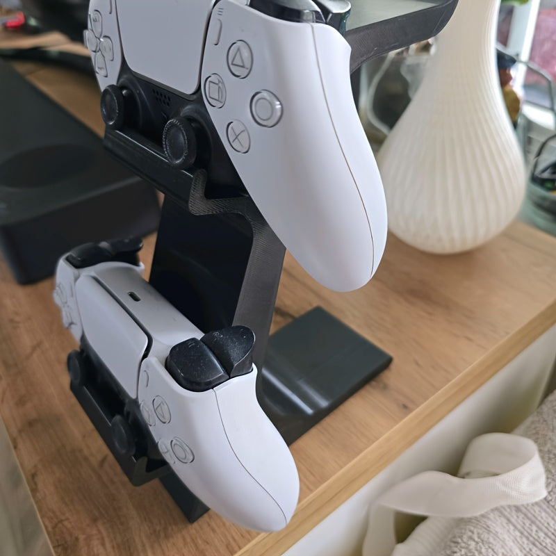 black 3-in-1 PS5 and Xbox Controller Stand – Compatible with PlayStation 5/Xbox Consoles. A gaming desktop organizer with a headphone hanger, non-charging base that holds 2 controllers and headphones. Space-saving white/black console accessory.