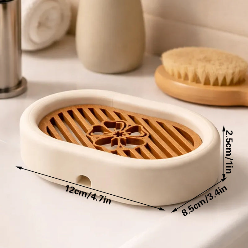 3D-printed oval soap dish with drain rack, white and wood-look.