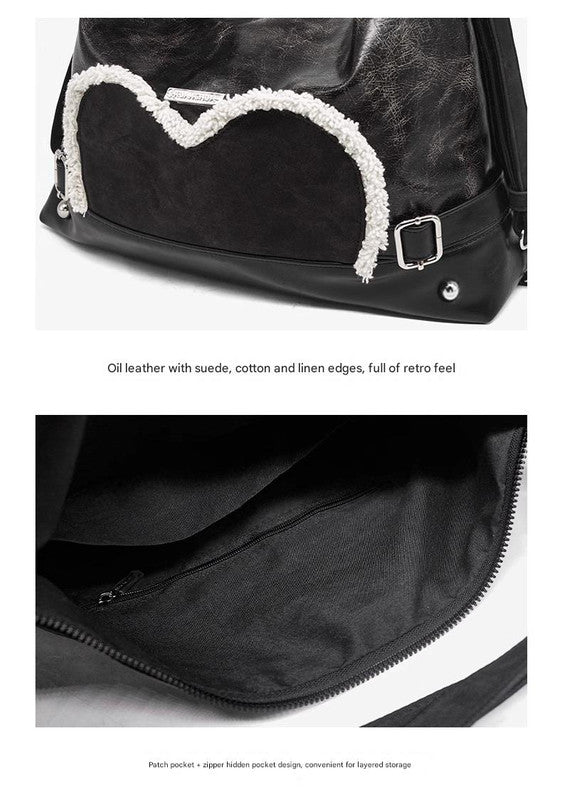 Stylish black tote backpack with heart embellishment - can be worn on one shoulder or as a backpack