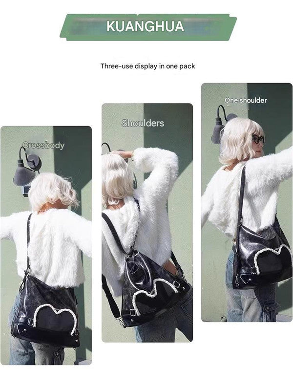 Stylish black tote backpack with heart embellishment - can be worn on one shoulder or as a backpack